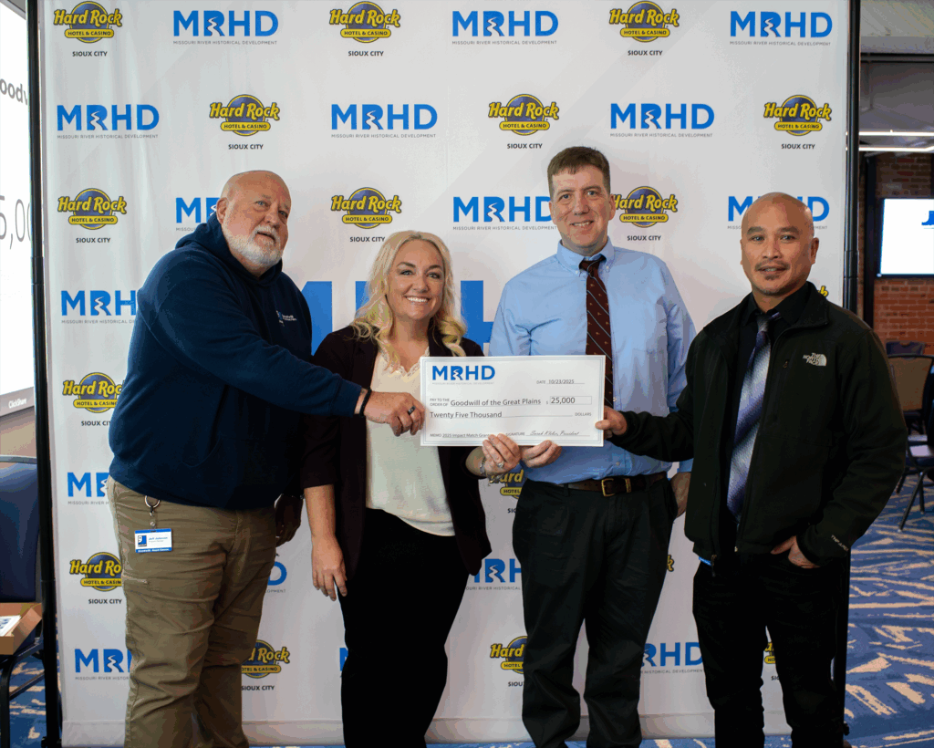 A group of Goodwill employees, including (from L to R) Jeff Johnson, Mitchell Kulawik and Vilay Keokenchanh, hold a large novelty check for $25,000, awarded by Missouri River Historical Development (MRHD) to Goodwill of the Great Plains during a ceremony on Thursday, Oct. 23rd inside Encore Hall at Sioux City's Hard Rock Hotel and Casino.